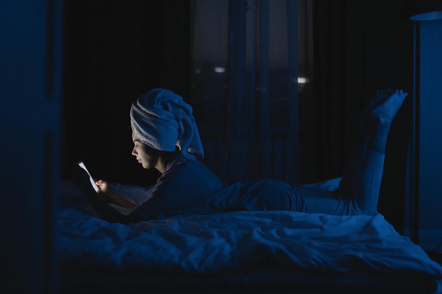 Person experiencing sleep problems from blue light exposure at night