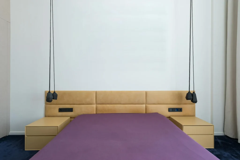 Modern adjustable bed base with elevated headrest in a bedroom