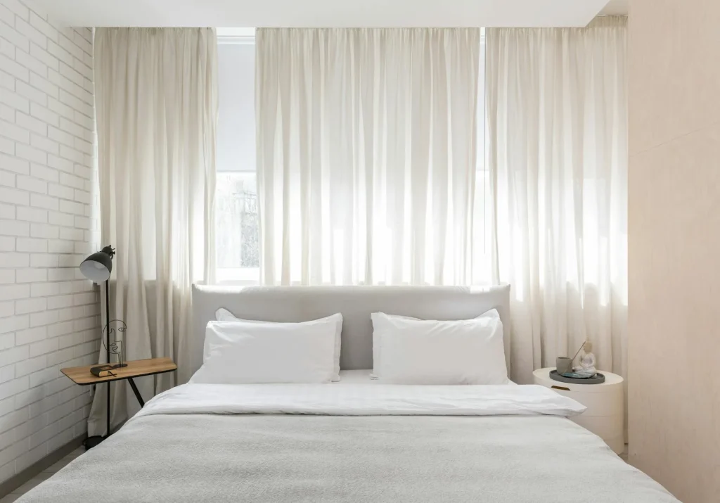 Neutral-toned UK bedroom with a made bed — Best Hybrid Mattresses 2026 review