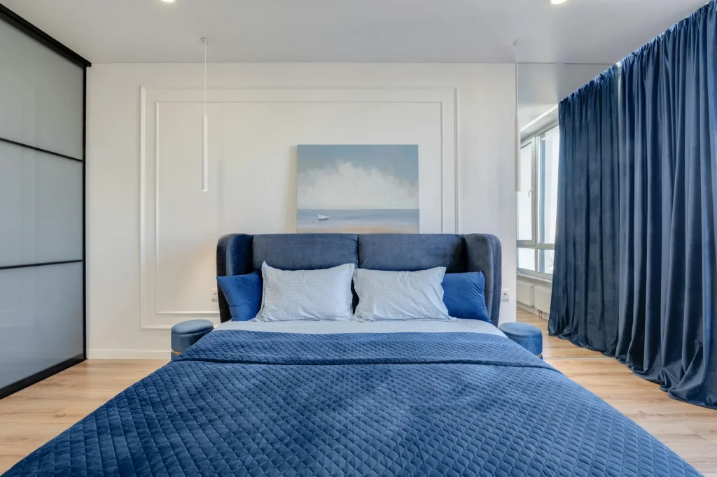 Calm blue bedroom interior with bed and pillows for restful sleep