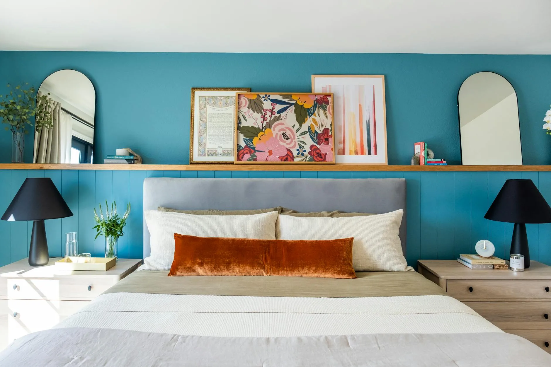 Cosy bedroom with bedside table and lamp beside pillows