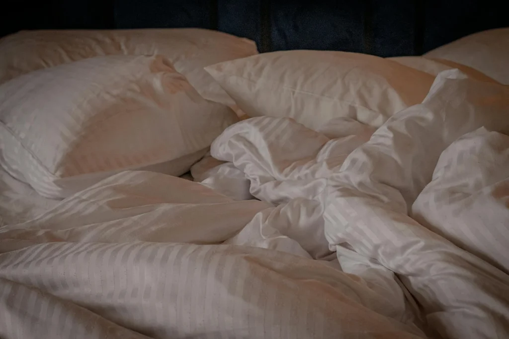 Fluffy white duvet on a neatly made bed in a cosy bedroom