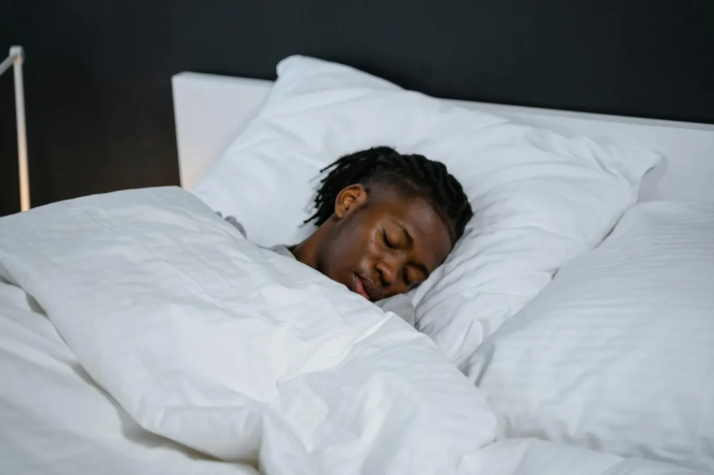 Person sleeping comfortably on a supportive mattress in a bedroom
