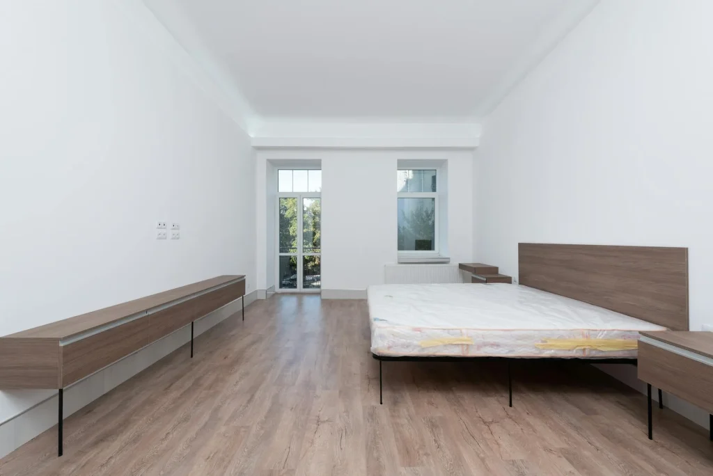 Modern bedroom showing wooden slatted bed frame supporting memory foam mattress