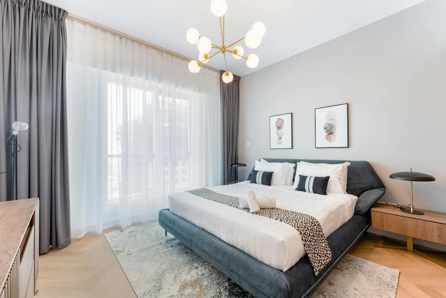 Modern UK bedroom with a king-size bed on a wooden frame and clean bedding