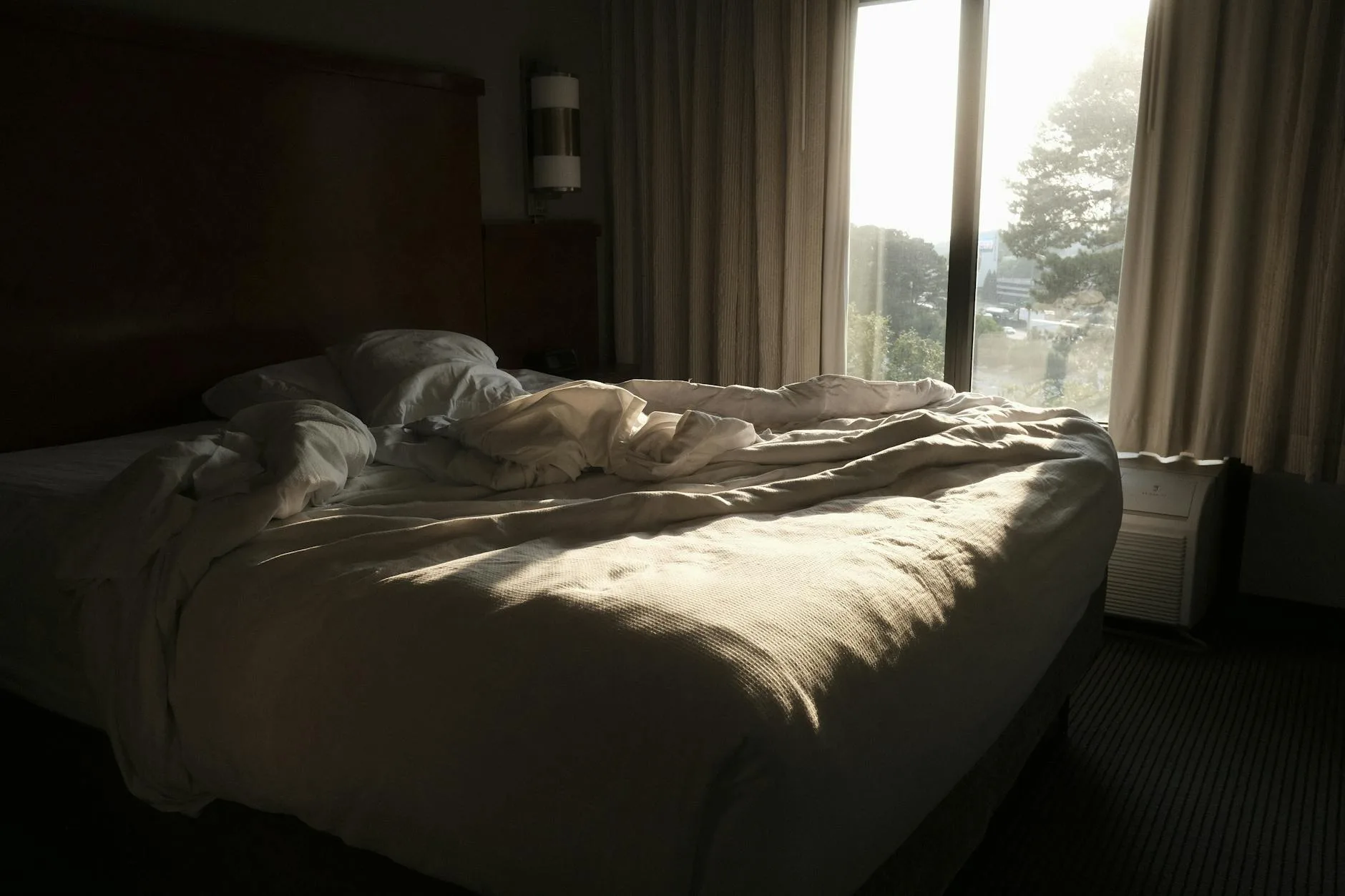 Morning sunlight streaming through a bedroom window at wake-up time