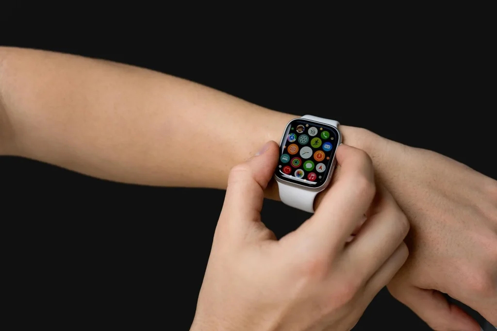 Person wearing a sleep tracking smartwatch while lying in bed