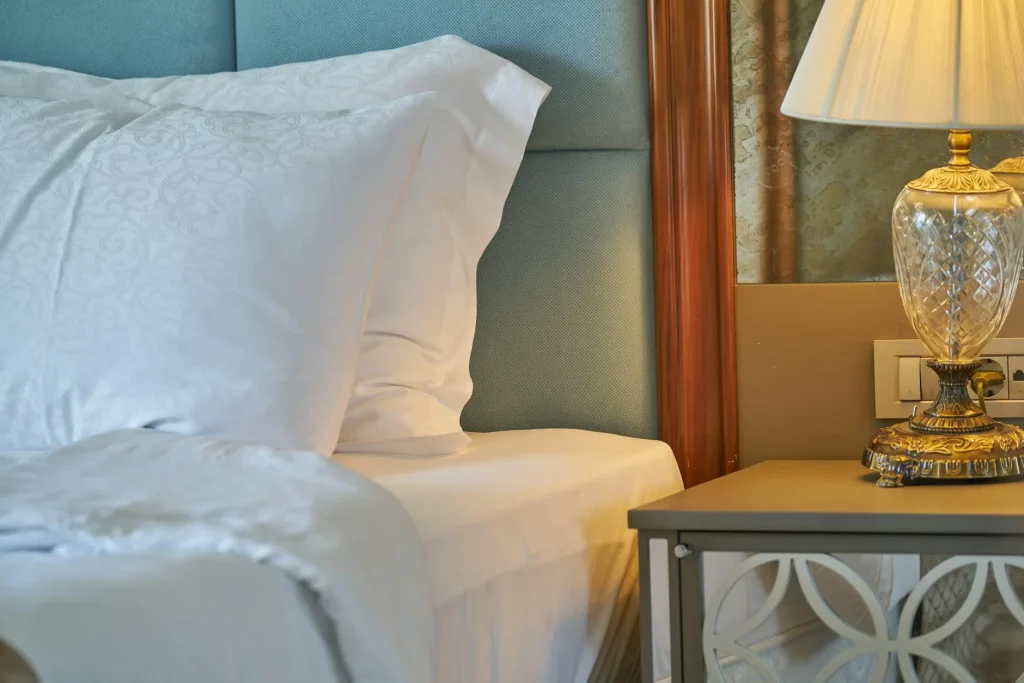 Silk pillowcase on a neatly made bed in a bright bedroom
