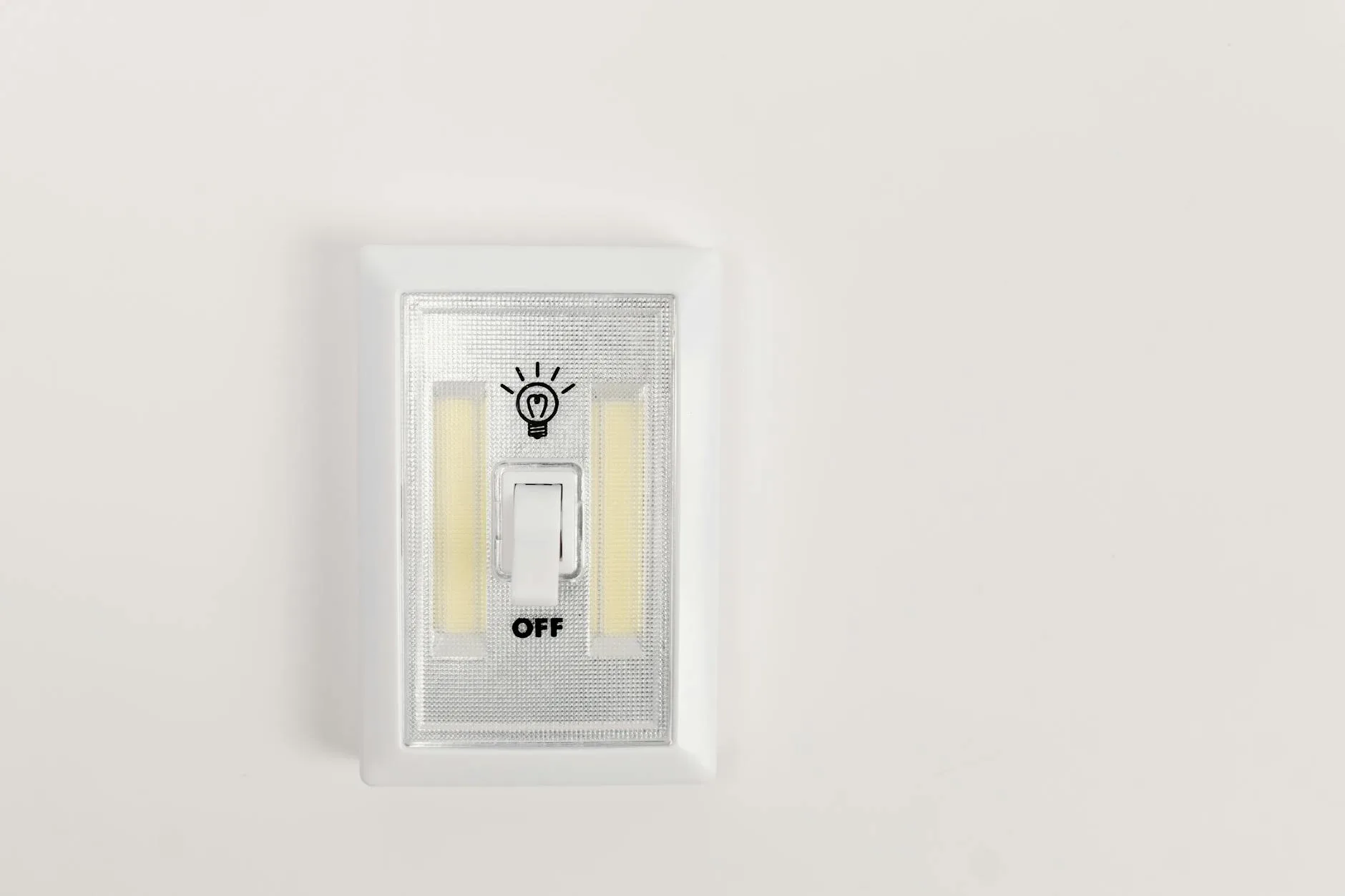 Hand adjusting a dimmer switch for bedroom lighting