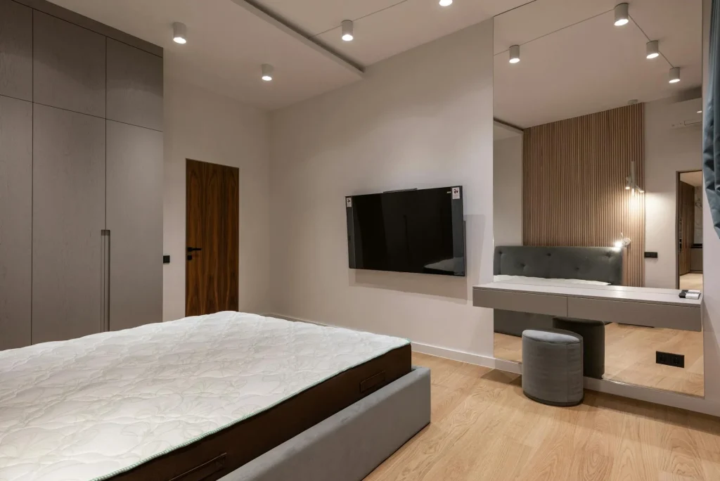 Thick comfortable mattress on a bed frame in a bright bedroom