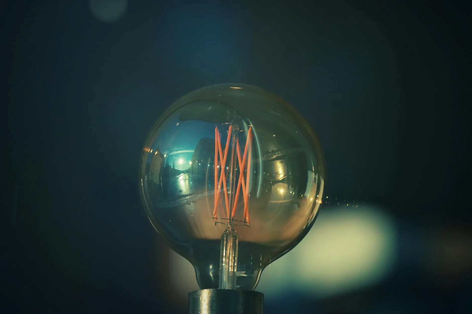 Smart light bulb casting a warm glow on a bedside table
