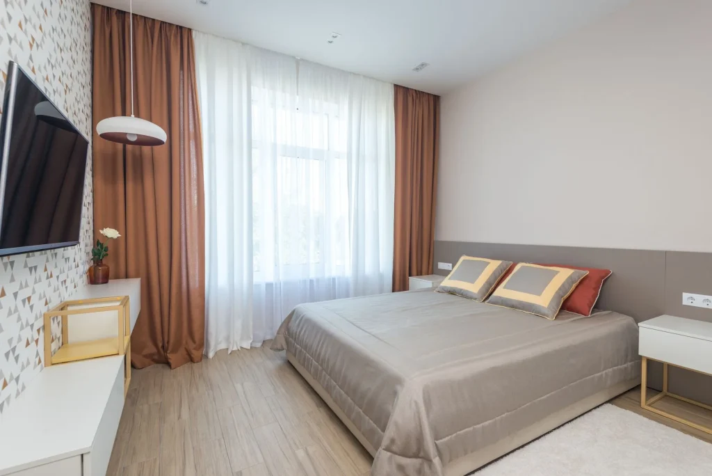 Cosy bedroom with warm lamp bedding and curtains