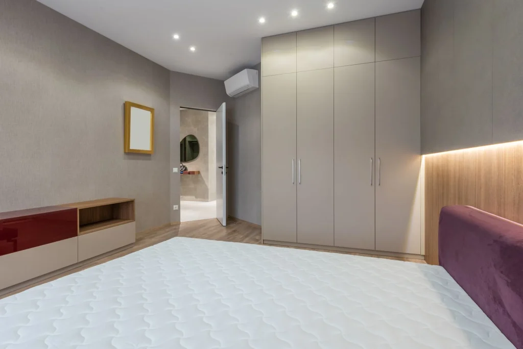 Mattress on a neutral bedroom bed for comparing mattress types