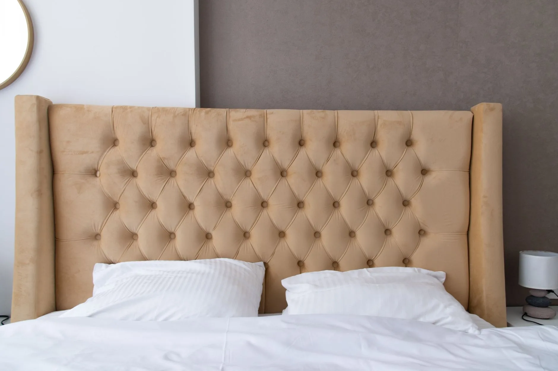 Mattress surface and bed base being checked before buying