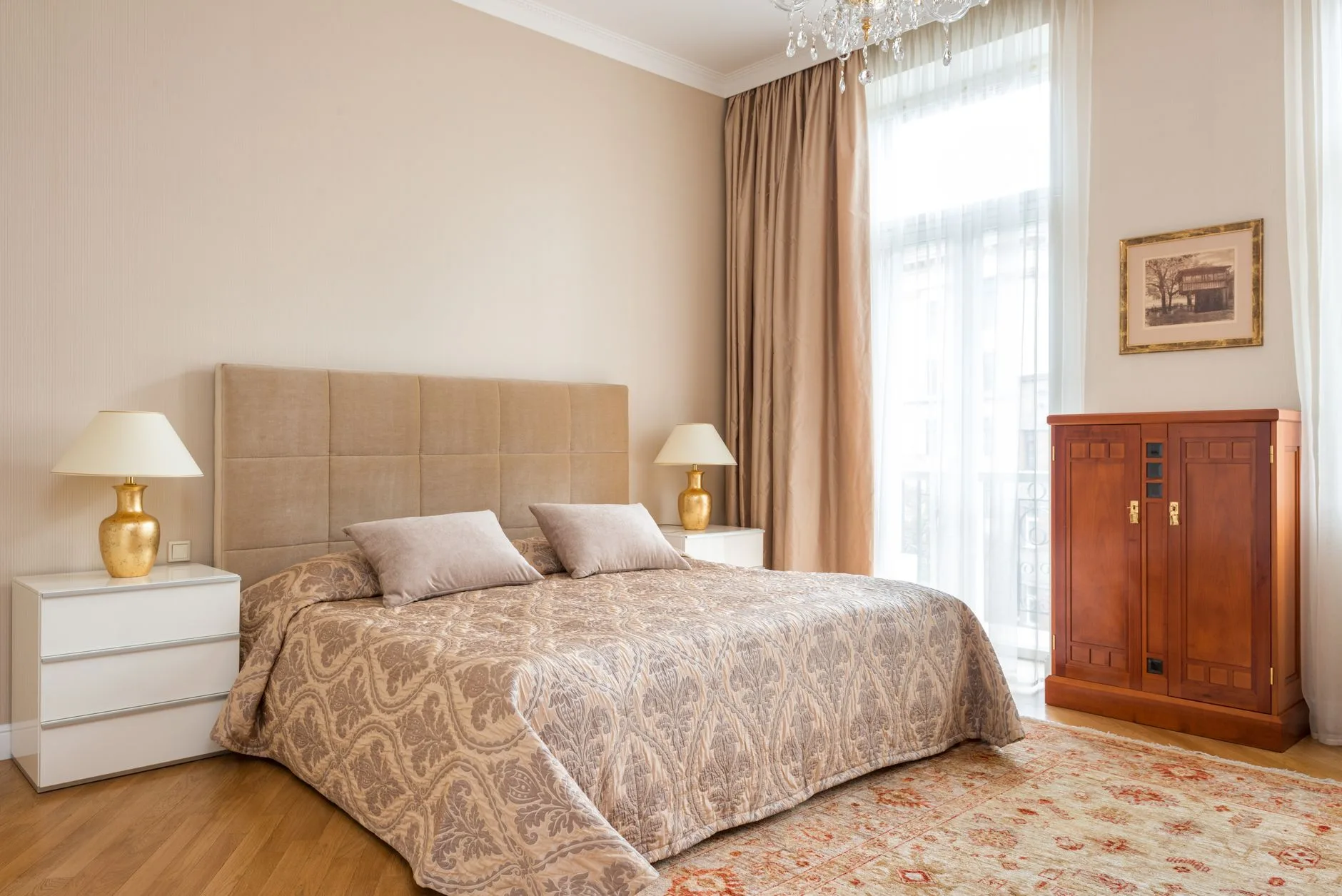 Bedside cabinet with drawers and lamp beside a bed