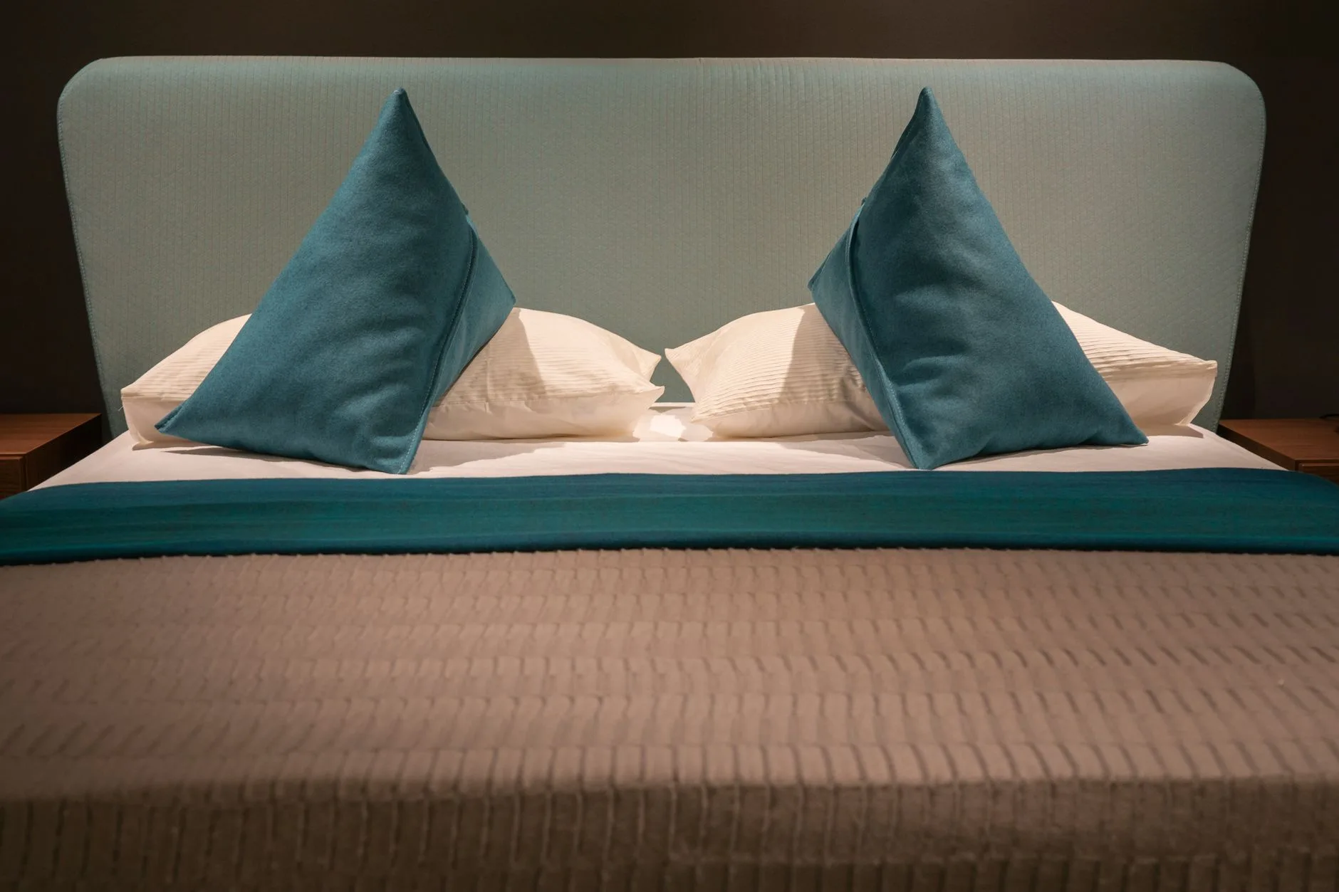 Crisp sheets and pillows arranged on a hotel-style bed