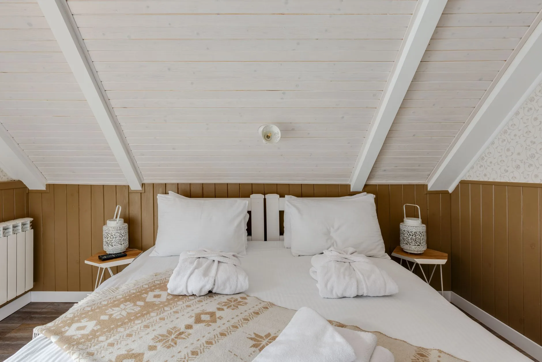 Folded warm blankets and winter bed linen on a bed
