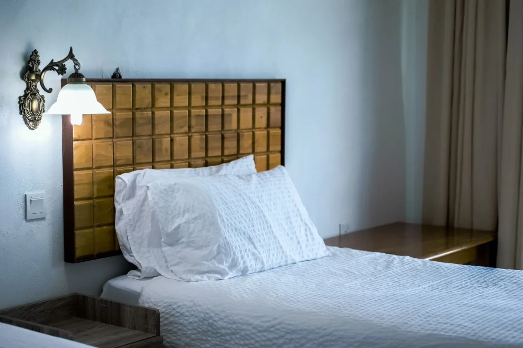 Hotel-style white bed with crisp bedding and pillows