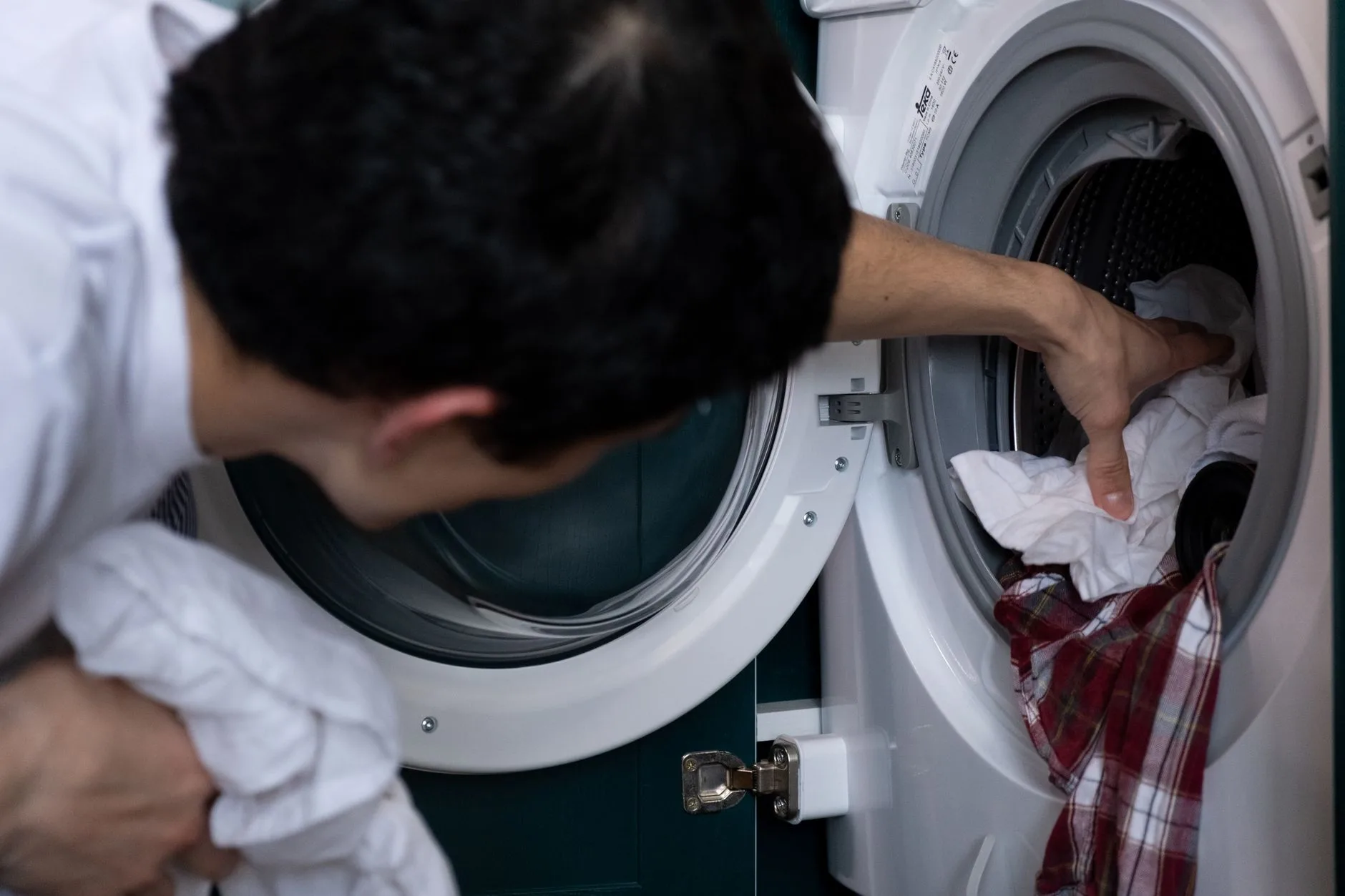 White bedding in a washing machine for allergy bedding care