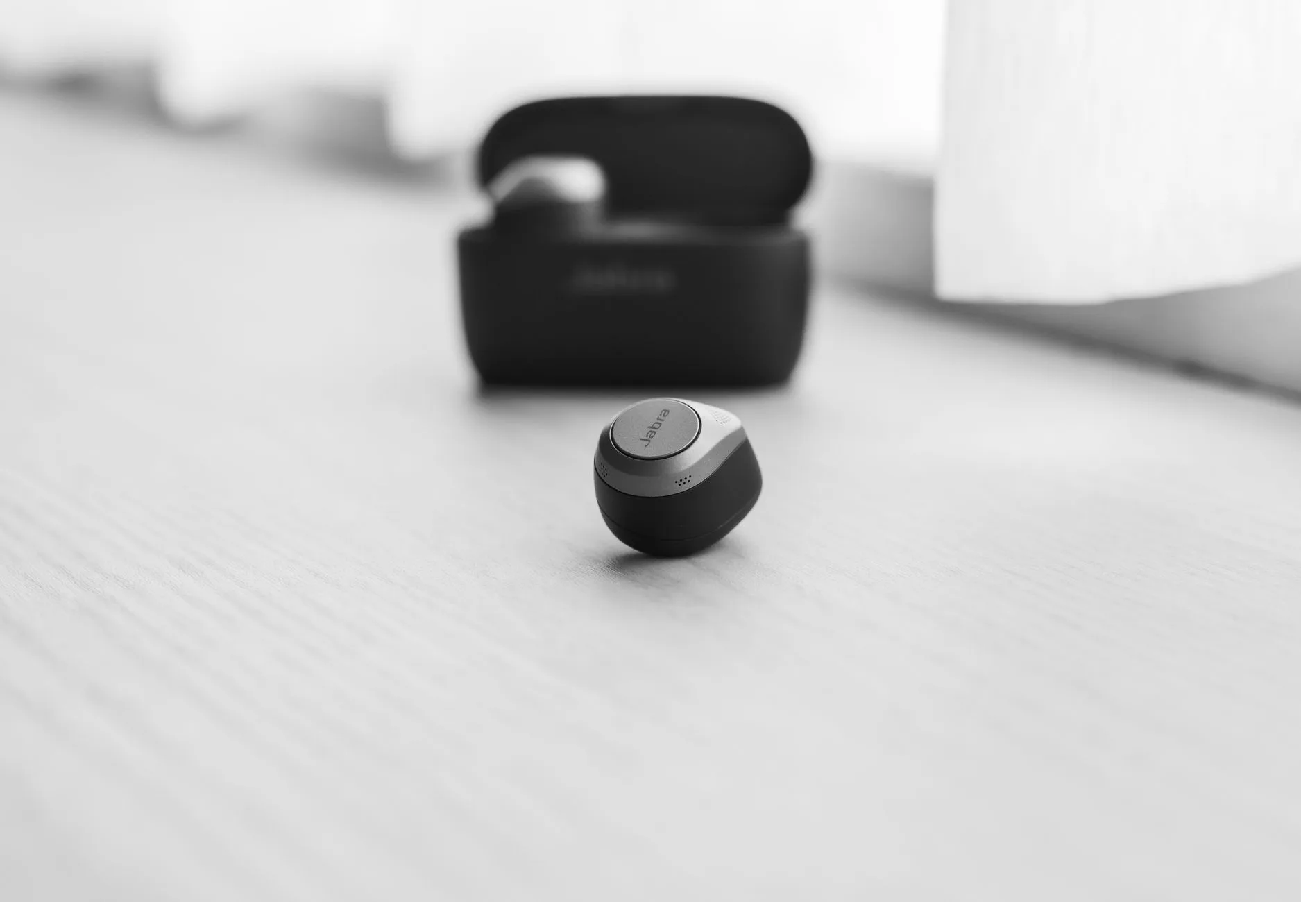 Bluetooth sleep earbuds charging case next to a pillow